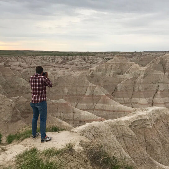 Man taking picture of south dakota sunset