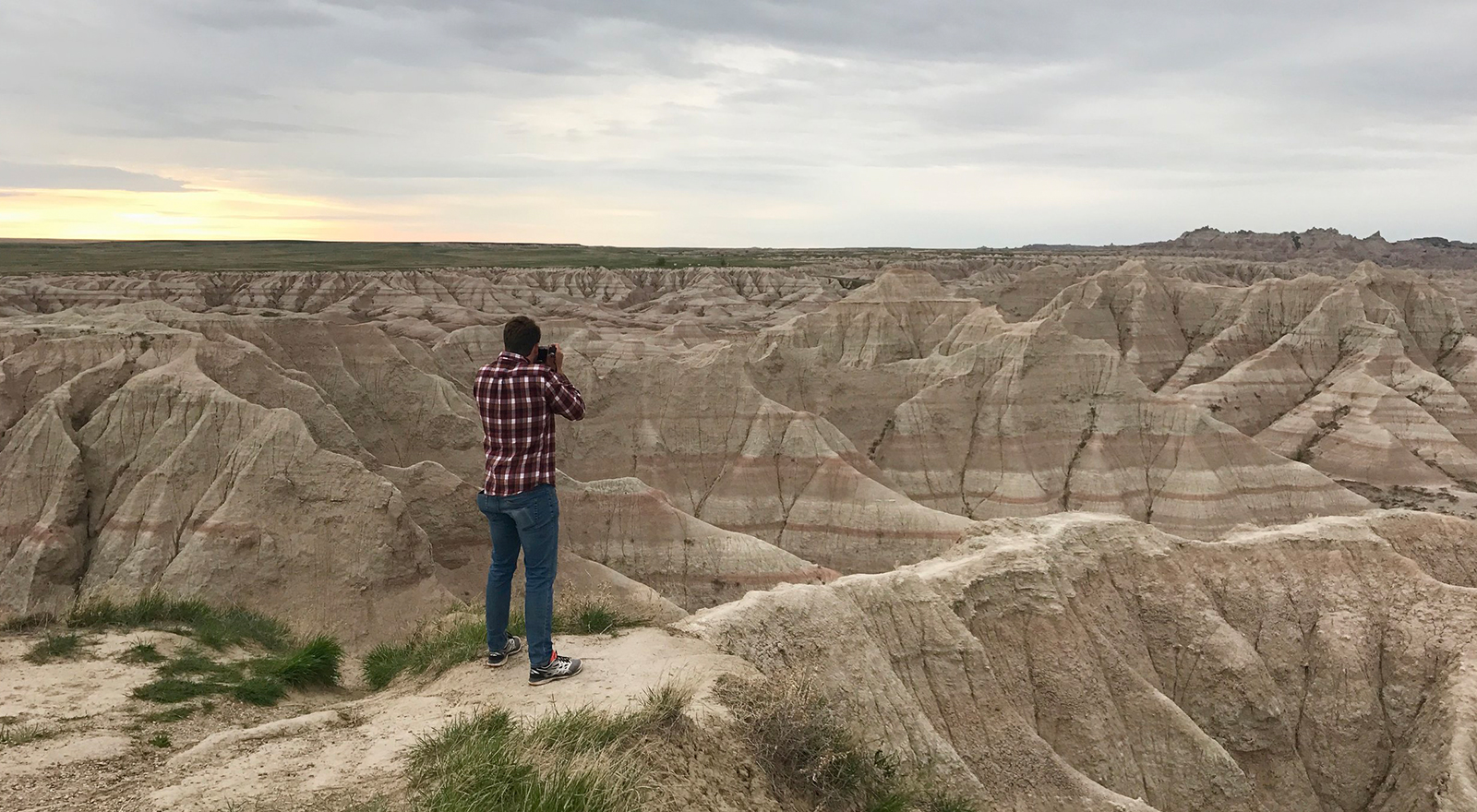 Man taking picture of south dakota sunset
