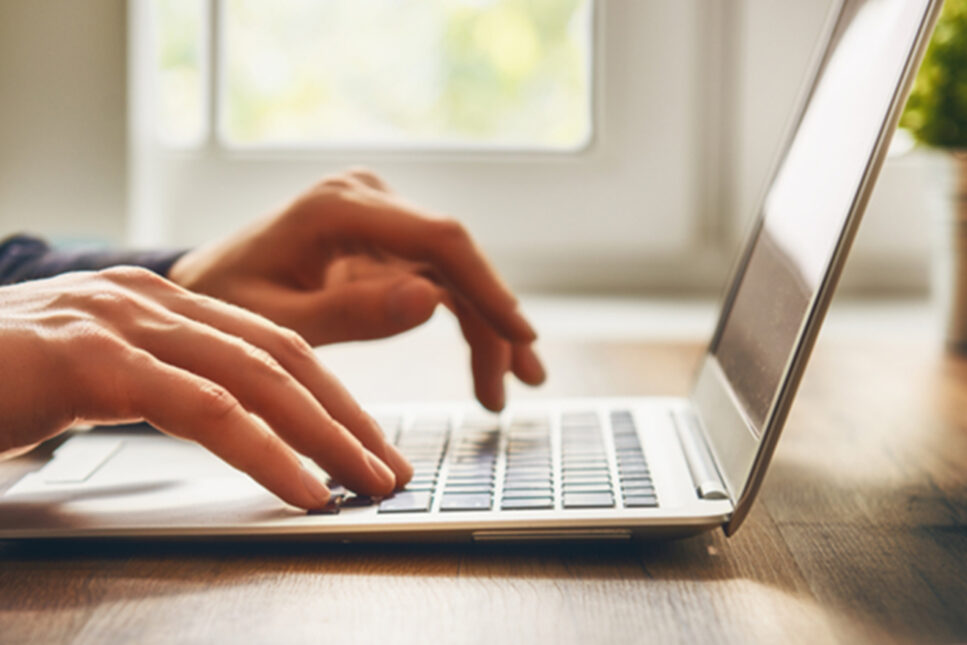hand typing on computer
