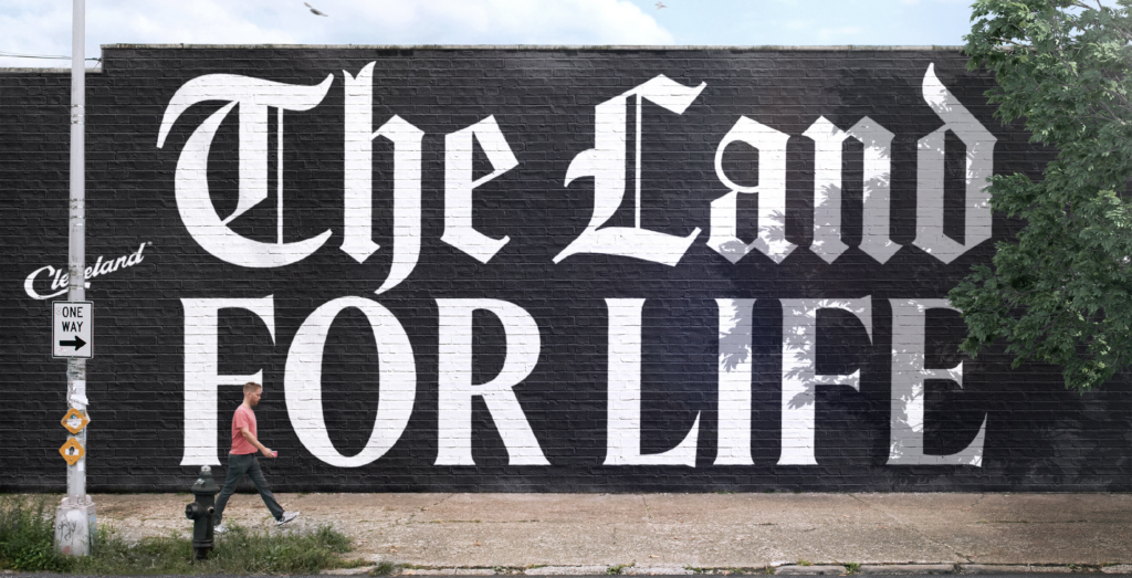 The Land For Life painted on the side of a building in beautiful, huge letters