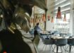Hotel restaurant, woman setting table